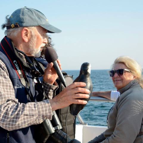 a man standing next to a body of water