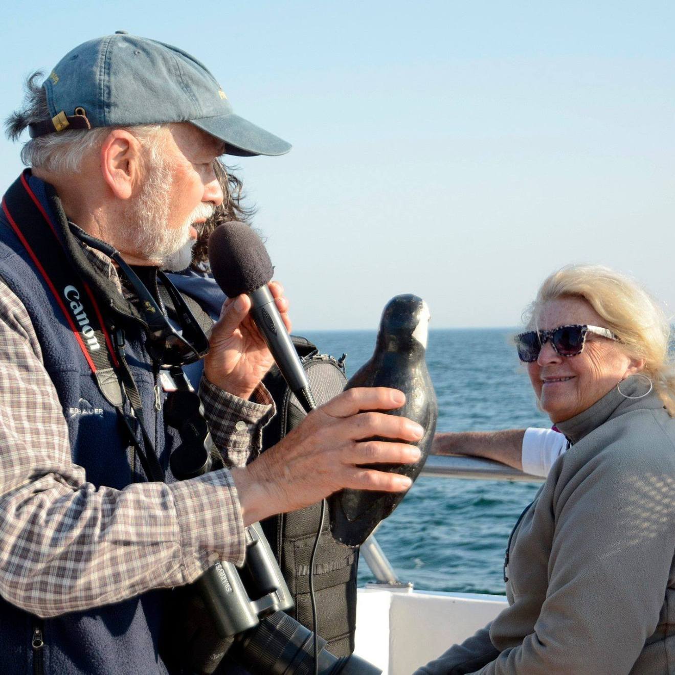 a man standing next to a body of water