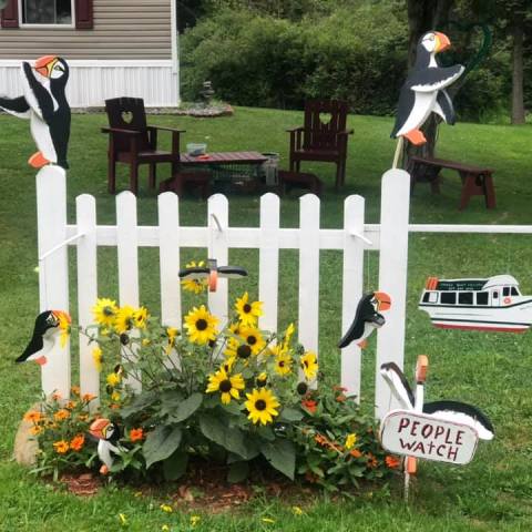a group of lawn chairs sitting on top of a grass covered field