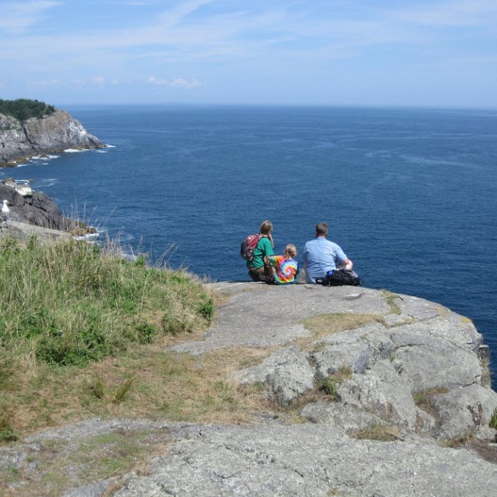 a rocky island in the middle of a body of water
