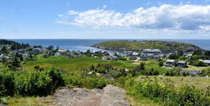 Wide Angle View of New Harbor a wide angle view of New Harbor, ME with green fields and houses on the water
