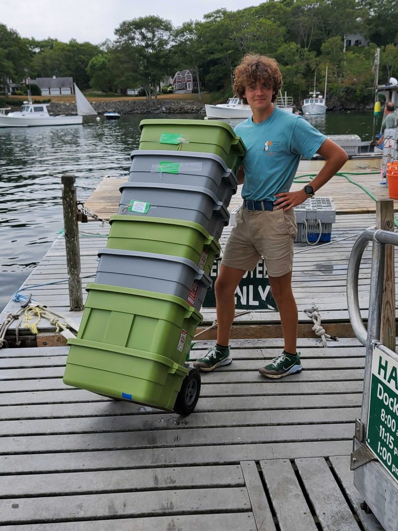 a man standing on a green bench
